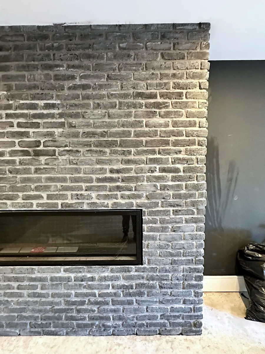 Floor-to-ceiling brick chimney breast