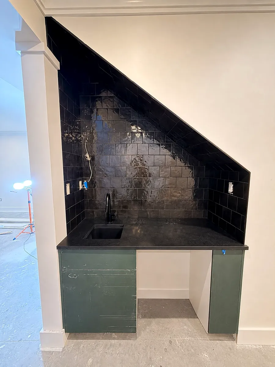 Wet bar under the stairs, charcoal tile