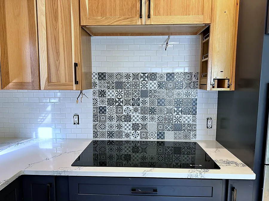 Patterned tile panel behind the cooktop