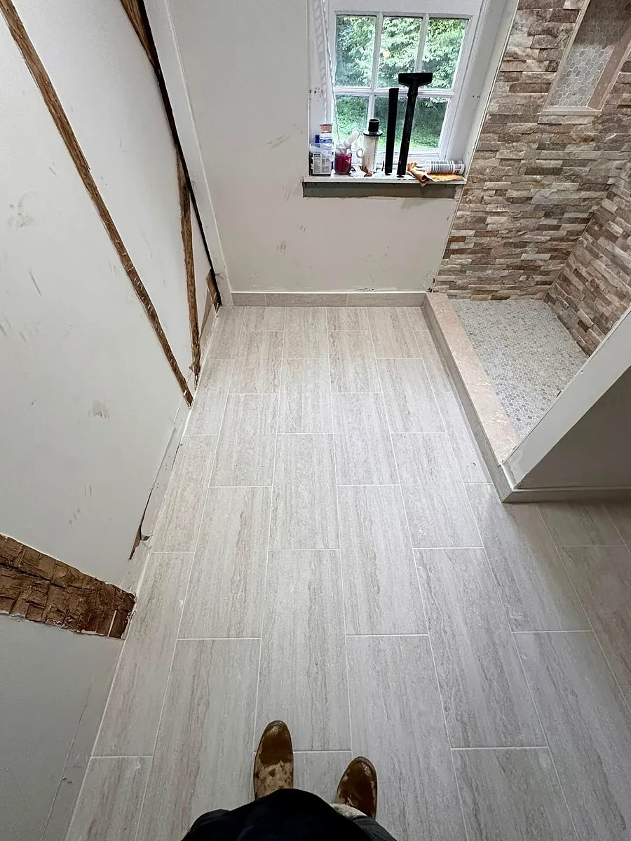 Hallway floor meeting a stone wall