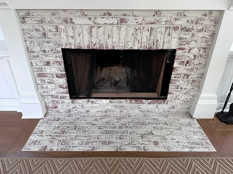 Whitewashed brick with a herringbone hearth